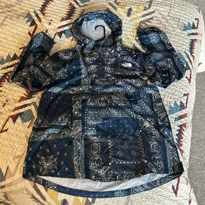 The north face anorak shell in size medium that folds into a fanny pack.